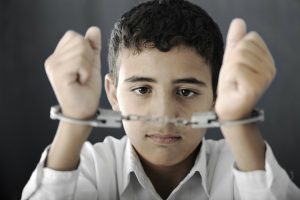 Child with handcuffs on